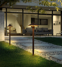 Evening scene of a path softly lit by solar mushroom lights, enhancing the outdoor ambiance.