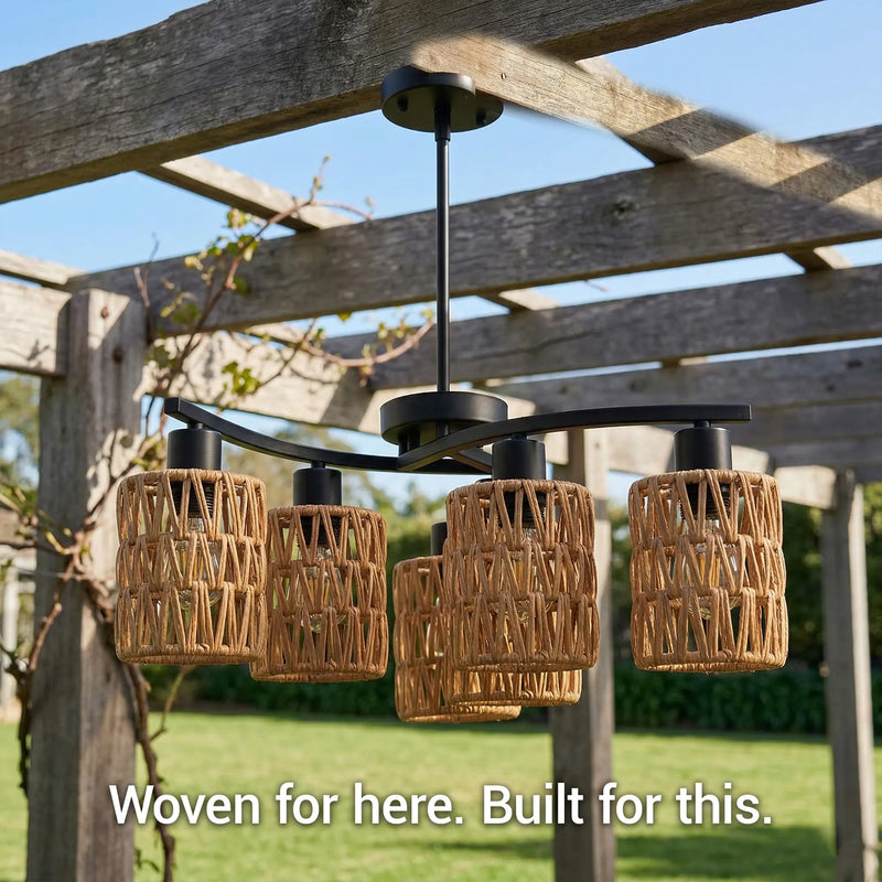 Woven outdoor light fixtures hanging from a wooden pergola with a garden background.