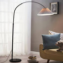 Floor lamp in a living room with a sofa and decorative pillows.