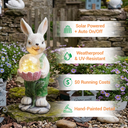 A solar-powered rabbit garden statue holding a crackle glass light globe, displayed in a garden setting with text callouts highlighting four features: Solar Powered + Auto On/Off, Weatherproof & UV-Resistant, $0 Running Costs, and Hand-Painted Detail.
