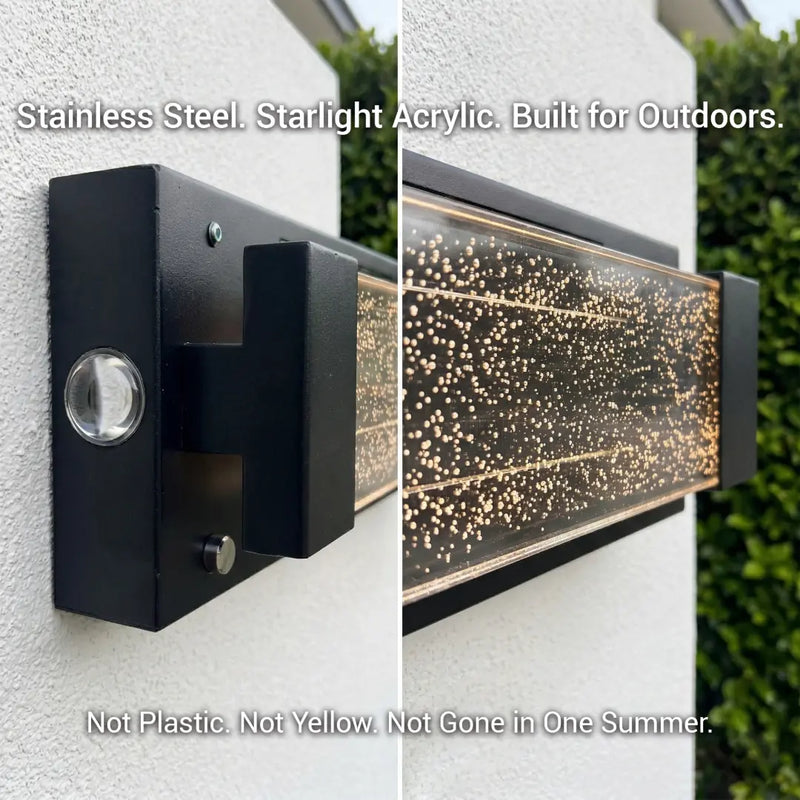 Outdoor light fixture made of stainless steel and starlight acrylic on a wall.