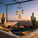 Boho woven pendant light fixture illuminating rooftop terrace with cacti at sunset