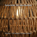 Extreme close-up of the handwoven PE rattan texture of the PT0906 lamp, with text overlay: “Handcrafted. Not Mass-Moulded.” and “PE rattan — UV-resistant. 3-5 years outdoors.”