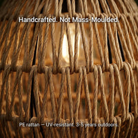 Extreme close-up of the handwoven PE rattan texture of the PT0906 lamp, with text overlay: “Handcrafted. Not Mass-Moulded.” and “PE rattan — UV-resistant. 3-5 years outdoors.”