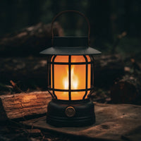 Close-up of retro flame lantern glowing on forest floor, realistic flicker effect visible through PC globe, UV-resistant finish.