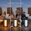 Outdoor table with three different light color temperatures on a deck.