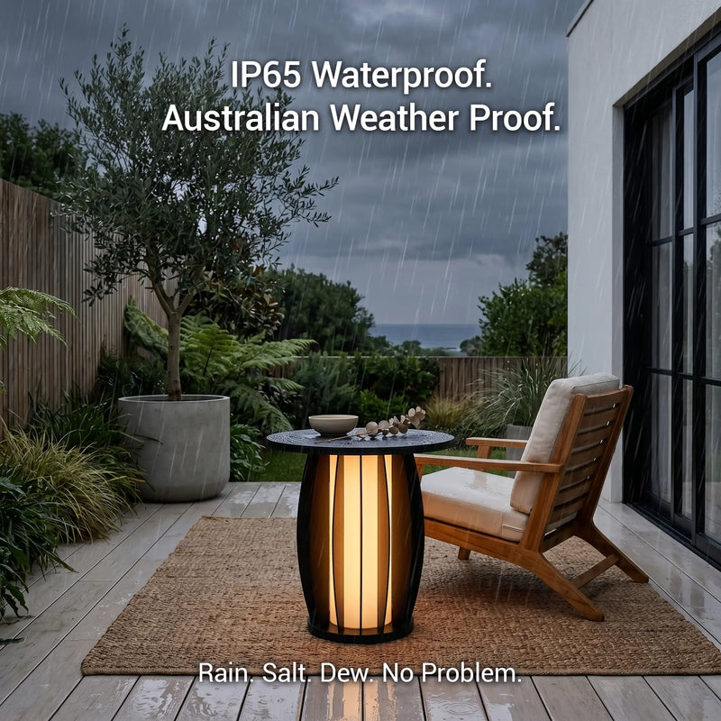 Outdoor patio with a table and chair on a wooden deck, rain falling, text indicating waterproof features.