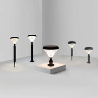 Set of modern outdoor solar lawn & pillar lights on a neutral background