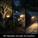 Three outdoor solar landscape lights shown at night in different garden settings: beside a tree, among flowers, and along a stone walkway. The lights are black and adjustable, casting warm white light on the surroundings.