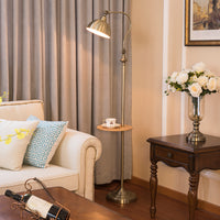 Living room with beige sofa, floor lamp, and side table with flowers