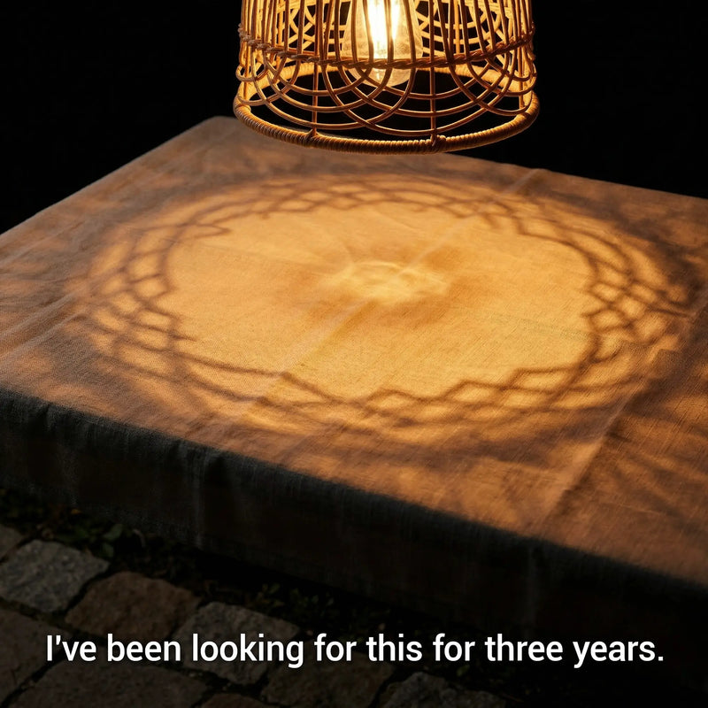 Wooden table with woven lampshade casting circular shadows on a dark background