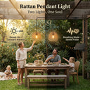 Family enjoying a meal outdoors under a wooden pergola with rattan pendant lights.