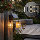 Solar-powered outdoor lights with control panel on a wooden post, garden setting.
