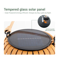 Solar-powered lamp with a glass panel, designed for garden or lawn use, featuring a handwoven aesthetic.