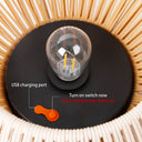 Solar Ceiling Light bulb with USB charging port and switch on a woven surface