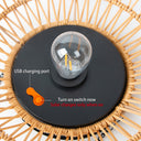 Solar light bulb with USB charging port on a woven surface