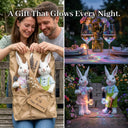 Collage of three images showing a couple unwrapping two white resin rabbit garden ornaments as a gift, a romantic rainbow-lit dinner table setting, and the boy and girl rabbit pair glowing with RGB colour-changing lanterns in a garden at night, with text overlay A Gift That Glows Every Night