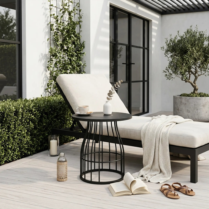 Outdoor seating area with a chair, small table, and plants on a wooden deck.