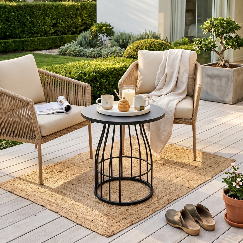 Outdoor seating area with two chairs, a small table, and a rug on a wooden deck.