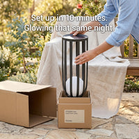 Person setting up a solar floor lamp outdoors with text indicating setup time and glowing feature.