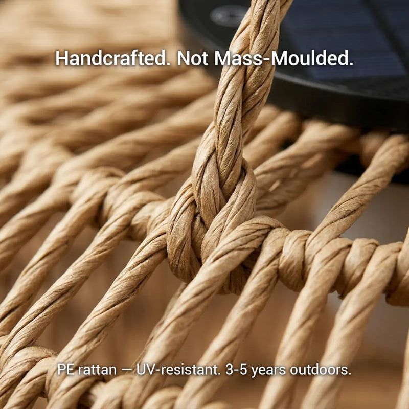 The PT0901 Kiku Solar Rattan Hanging Lantern hanging in a bright, modern indoor dining room, showcasing its versatility as a stylish decor piece for both inside and outside.