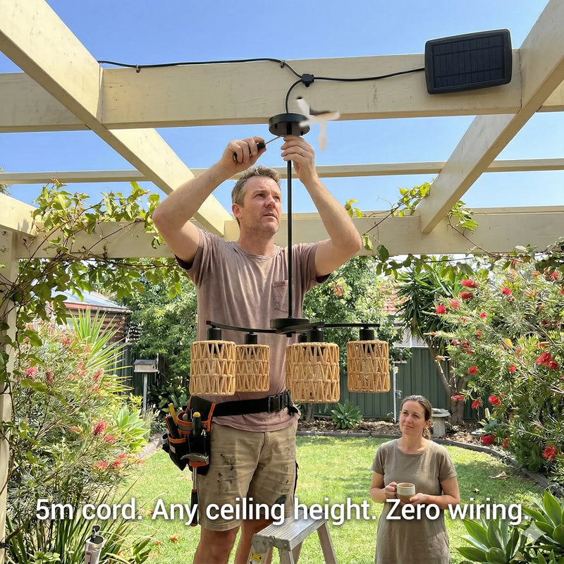 Man installing outdoor lighting fixture with woman observing in a garden setting