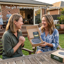 Woman opening a Niteo solar light gift box in a backyard setting, showing the premium packaging of the solar garden light kit.