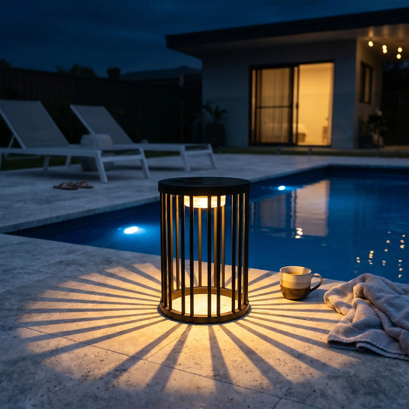 Lamp by a poolside at night with a house in the background