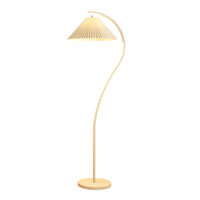 A modern floor lamp with a curved wooden stand, a round base, and a pleated shade on a solid white background.