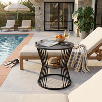 Outdoor patio scene with lounge chairs, a table, and pool in the background