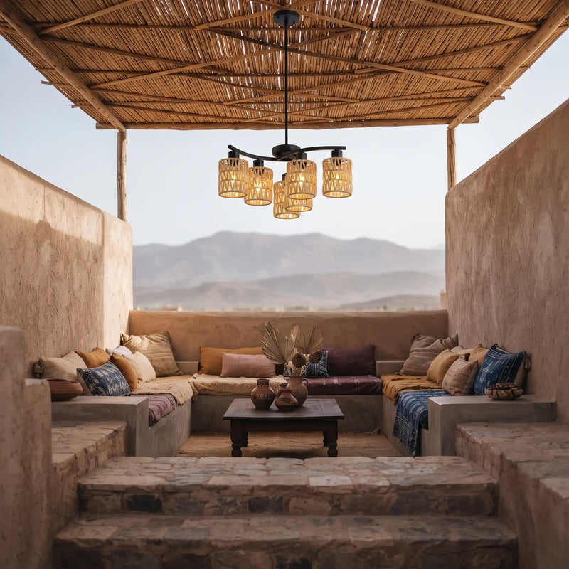 Close up of black five-arm chandelier featuring handwoven rattan cylinder drum shades
