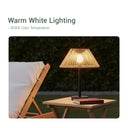 A table featuring a Solar Handwoven Table Lamp with a warm white lighting effect.
