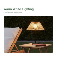 A table featuring a Solar Handwoven Table Lamp with a warm white lighting effect.