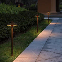 Solar mushroom pathway lights illuminate a garden pathway, enhancing the outdoor ambiance with soft, warm lighting.