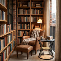 Cozy reading nook with bookshelves, armchair, and small table.