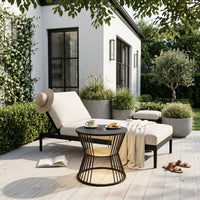 Outdoor seating area with a chair, table, and plants in a garden setting.