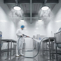 Outway high bay LED lights operating in a commercial kitchen during high-pressure steam cleaning, demonstrating IP65 waterproof performance in a food-safe environment.