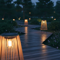 A pathway illuminated by several solar handwoven garden lawn lights, creating a warm and inviting atmosphere.