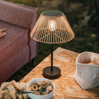 A table featuring a solar lamp and a bowl of food, creating a cozy dining atmosphere.