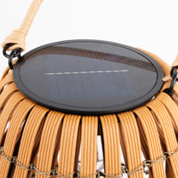 Solar lawn light with woven design on a white background