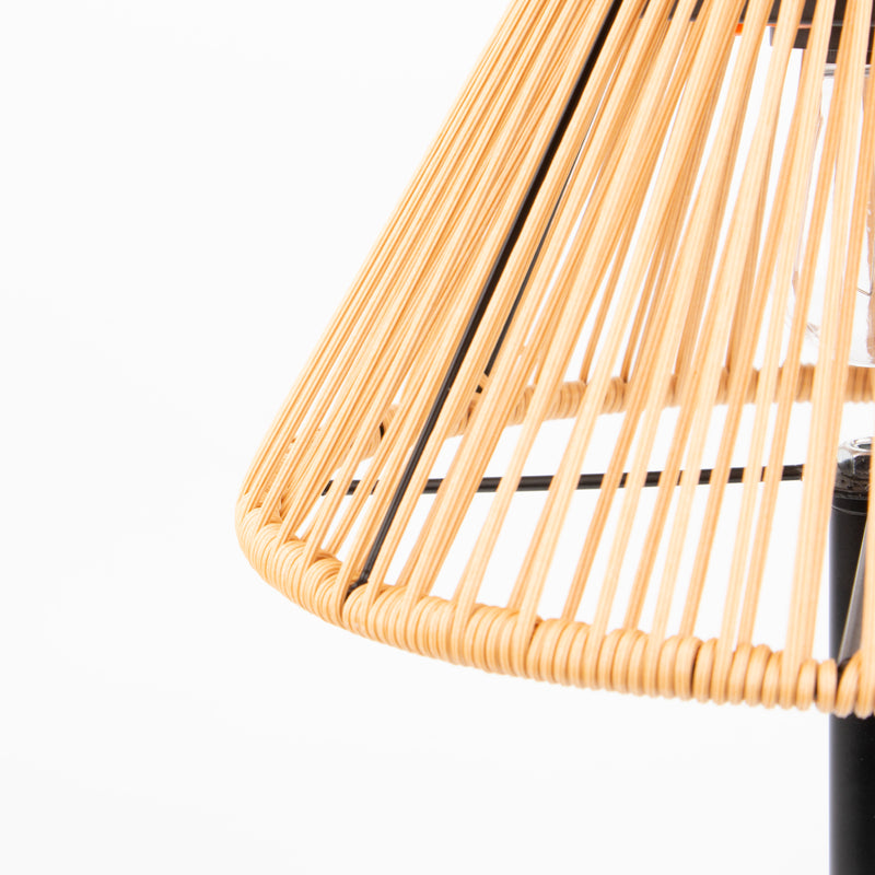 Close-up of a woven natural rattan or wicker lampshade with thin dark support rods, shown against a plain white background.