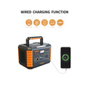 A portable power station with orange and black panels is shown wired to a smartphone displaying a 97% battery level. The image includes the text 'WIRED CHARGING FUNCTION' and small orange icons indicating compatible devices: phones, cameras, GPS devices, laptops, and cars.