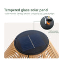 A circular black tempered glass solar panel with a blue photovoltaic surface, mounted on a woven rattan structure. The image includes marketing text and a circular inset showing a USB charging port on the panel with an included cable.