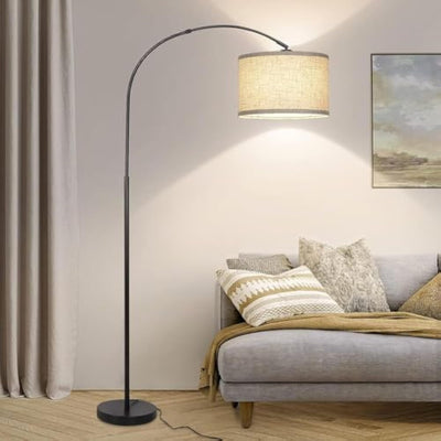 Elegant arched floor lamp next to sofa in living room.
