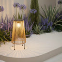 HAlKU solar bamboo path light glowing warm whitebeside a pool at dusk-handwoven rattan gardenlamp