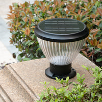 Black and white solar pillar light, designed for outdoor use, illuminating spaces with eco-friendly solar power.