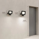 Two black wall-mounted floodlights shown on a light gray wall with overlaid height measurements (147mm, 171mm, and 2000mm) relative to a gray door.