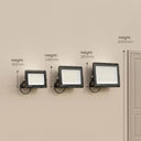Three black wall-mounted LED floodlights shown on a beige wall with height measurement labels and arrows indicating 183mm, 248mm, 285mm, and 2000mm.