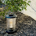 Compact solar LED lamp with carry ring, ideal for camping and garden pathways.