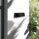 Solar wall mount light with waterproof design for outdoor patios and gardens.